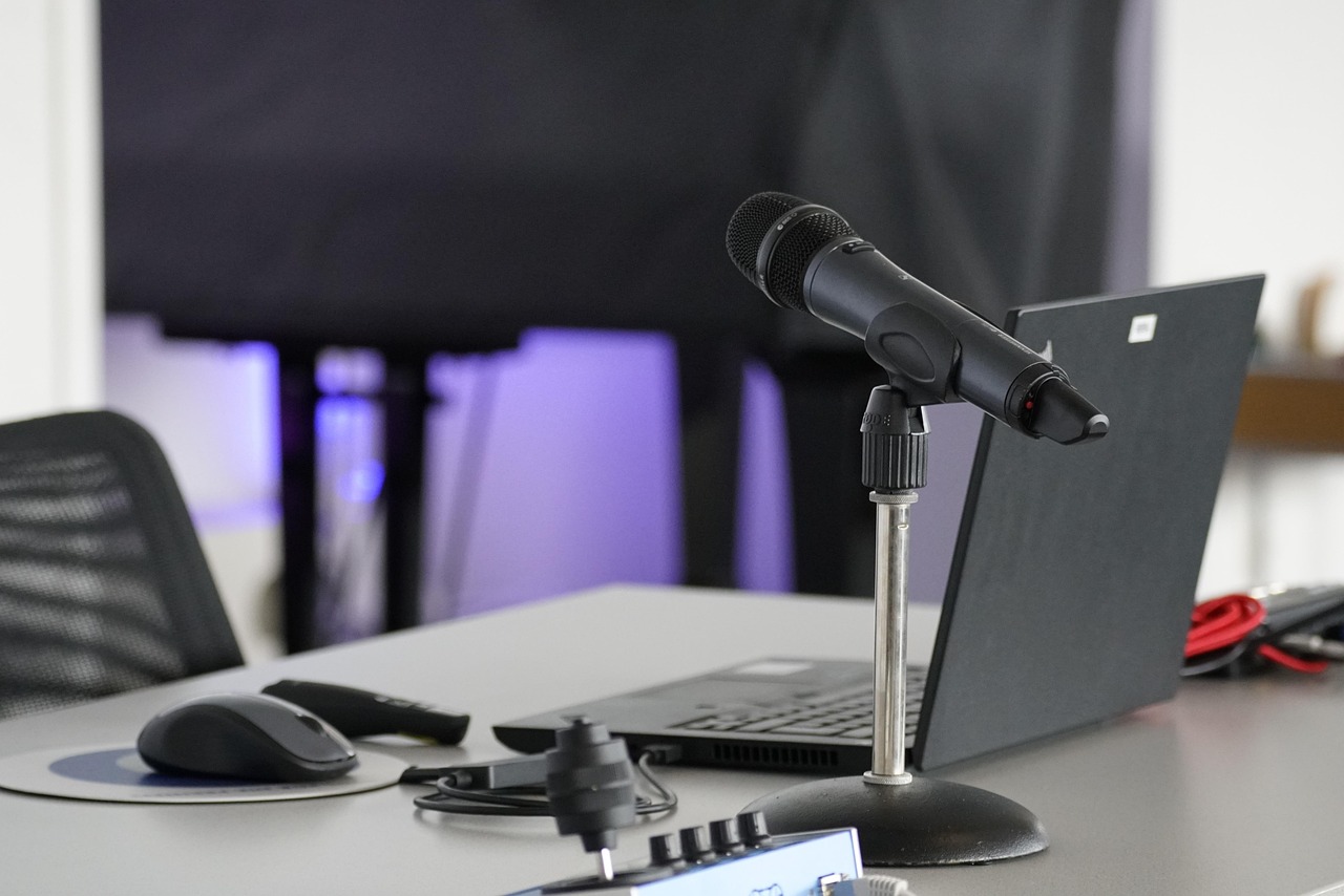 Laptop, conference table, mouse — Mastering Poker Through Study and Practice